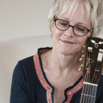 Photo of Tracy Newman and her Goodall guitar - Photo by James F. Dean.